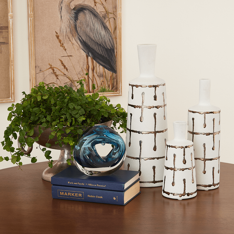 Two decorative ceramic objects on a shelf