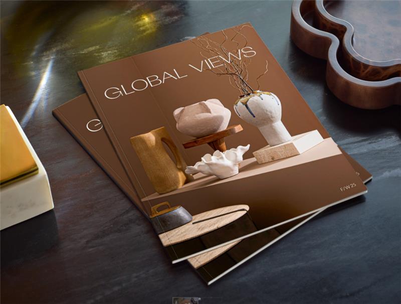 A collection of contemporary blue and white vases displayed on light wooden plinths, lit by soft window light.